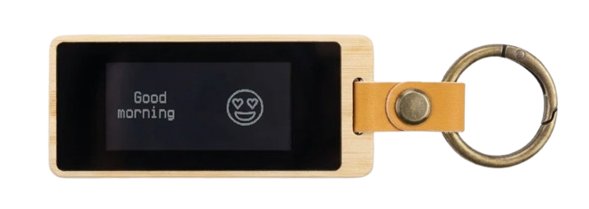 The KEEP V2 result — a clean bamboo keychain with a black-and-white e-ink screen reading 'Good morning.'