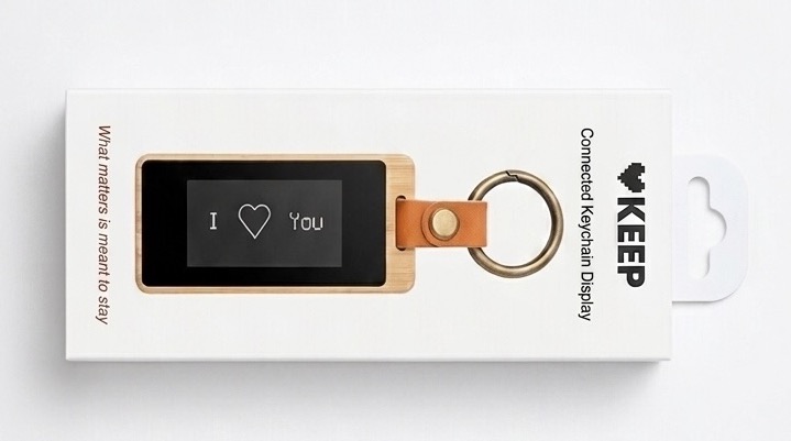 The finished KEEP — a bamboo keychain with a black-and-white e-ink screen reading 'I love you' — sitting in its retail packaging.